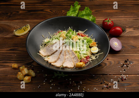 Caesar San Salad of Romano leaves, chicken in batter with cherry tomatoes, quail egg, breadcrumbs, Parmesan cheese, Caesar sauce and tobiko Stock Photo