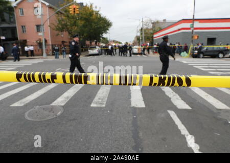 Beijing, USA. 12th Oct, 2019. Police cordon off a street near the scene of a shooting in New York, the United States, on Oct. 12, 2019. Four people were killed and three others injured in a shooting in New York's Brooklyn borough on early Saturday, according to the police. Credit: Zhang Mocheng/Xinhua/Alamy Live News Stock Photo