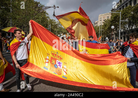 Barcelona, Spain. 12th Oct, 2019. Protesters wave the Spanish flags during the demonstration.About 10,000 people have participated in the demonstration held on the occasion of October 12, Hispanic Day called by entities favourable to the unity of Spain. The demonstration was supported by the prominent members of political parties with national representation such as the Popular Party, Vox and Ciudadanos. Credit: SOPA Images Limited/Alamy Live News Stock Photo