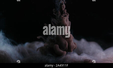Black and silver paint in water, abstract patterns. The concept of a terrifying and mystical. Stock Photo