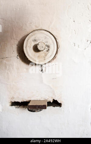Traditional, old Russian stove. The Valve on which lies a box of matches and a hole with a round lid. Close-up. Stock Photo