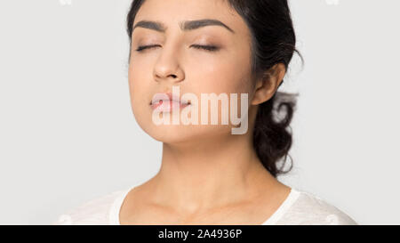 Close up of indian girl meditating with eyes closed Stock Photo