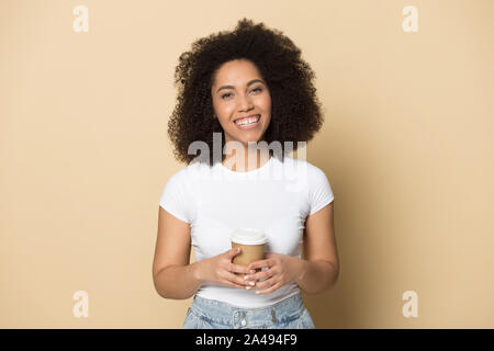 Smiling african American millennial girl enjoy takeaway coffee Stock Photo