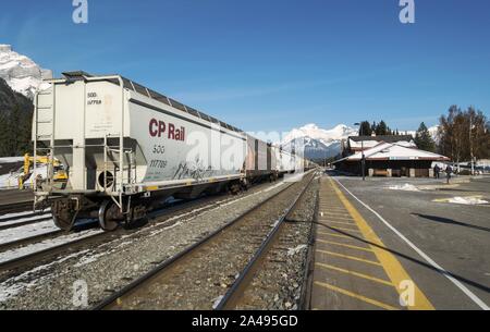 CP Canadian Pacific Railway Freight Train Cars Stopped Banff National Park Heritage Railway Station Alberta Canada Snowy Rocky Mountain Peak Skyline Stock Photo