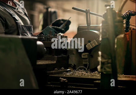 man working on a lathe
