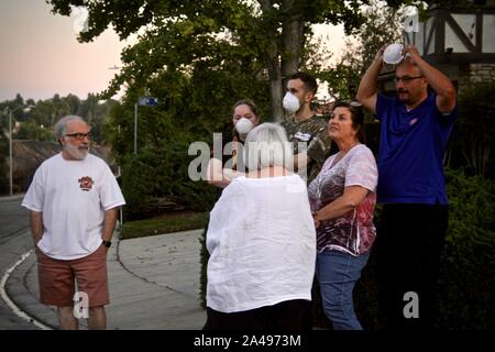 Sylmar, California, USA. 12th Oct, 2019. Evacuees return home and look on at the house burning across the street. Credit: Amy Katz/ZUMA Wire/Alamy Live News Stock Photo