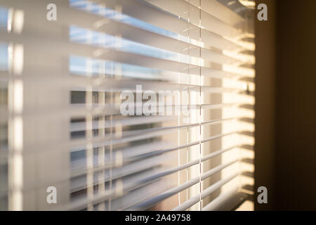 Morning sunlight coming through venetian blinds by the window Stock Photo