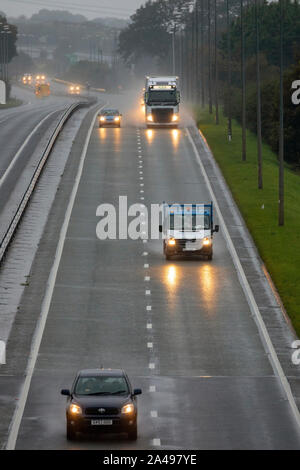 Flintshire, North Wales, UK 13th October 2019. UK Weather:  A deluge of torrential rain will full over the UK with many parts under heavy rain showers and in some places fog.  Motorists on the A55 as they pass through Flinthsire near Halkyn as torrential rain begins to fall. © DGDImages/AlamyLiveNews Stock Photo