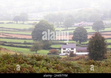 Flintshire, North Wales, UK 13th October 2019. UK Weather:  A deluge of torrential rain will full over the UK with many parts under heavy rain showers and in some places fog. A soggy foggy day in rural Flintshire as the rain and fog decends over the village of Rhes-y-Cae © DGDImages/AlamyLiveNews Stock Photo