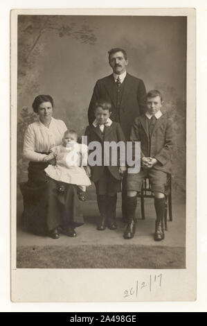 WW1 era studio portrait postcard of family group, dated 26.2.17 on front, U.K.
