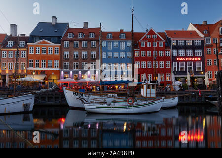 COPENHAGEN, DENMARK - MAY 25, 2017: Colourful facades and restaurants on Nyhavn embankment and old ships along the Nyhavn Canal in Copenhagen, Denmark Stock Photo