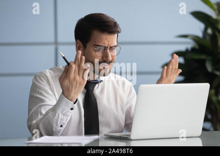 Angry manager irritated by poor internet connection. Stock Photo
