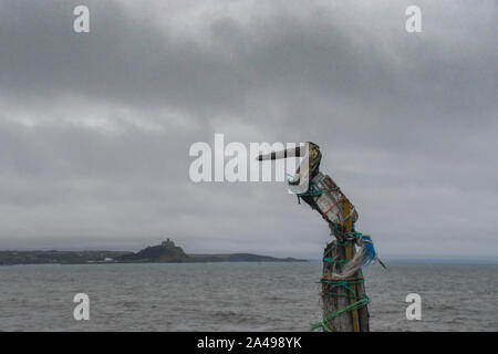 Chyandour, Cornwall, UK. 13th October 2019. UK Weather. Early morning cloud and rain obscured the sunrise this morning for most of Cornwall. See here a driftwood Heron looking towards St Michaels Mount.  Credit Simon Maycock / Alamy Live News. Stock Photo