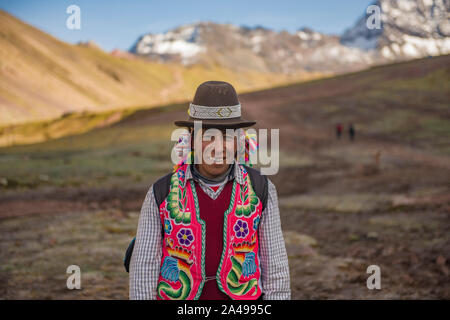 Vinicunca, Cusipata, Peru - June 08, 2017: Peruvian Andean man wearing traditional colorful clothing in the Vinicunca Valley, near Cusco Stock Photo