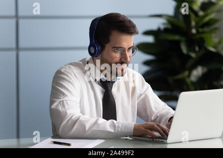 Happy male entrepreneur watching educational webinar. Stock Photo