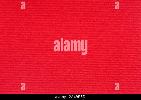 Abstract red background or Christmas texture. Bright red lined paper close-up. Stock Photo