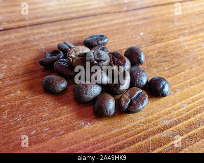Roasted Coffe beans composition on wood background, italian espresso  Stock Photo