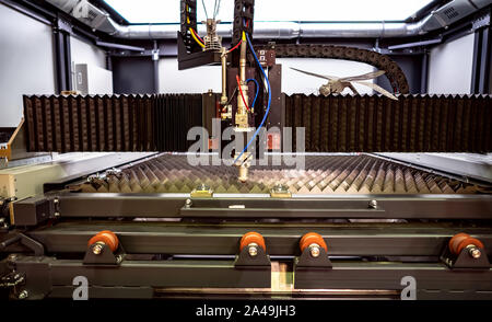 CNC Laser cutting of metal modern industrial technology. Laser cutting works by directing the output of a high-power laser through optics. Laser optic Stock Photo