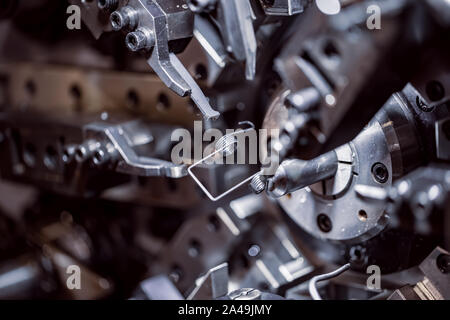 Cnc Wire Forming Machine, modern CNC spring machines for production of different types of wire bends. Stock Photo