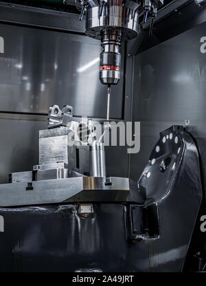 Quality control measurement probe. Metalworking CNC milling machine. Cutting metal modern processing technology. Stock Photo