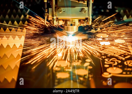 CNC Laser cutting of metal modern industrial technology. Laser cutting works by directing the output of a high-power laser through optics. Laser optic Stock Photo