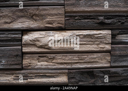 Natural stone bricks as a decoration on a wall. Natural stone wall texture. The walls are made of stones or marbles. Decoration for the walls or Stock Photo