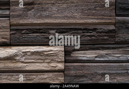 Natural stone bricks as a decoration on a wall. Natural stone wall texture. The walls are made of stones or marbles. Decoration for the walls or Stock Photo