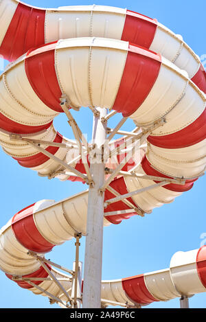 Close up of tube water slide in aqua park against blue sky Stock Photo