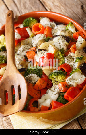 vegetarian vegetable casserole with cheese close-up in a baking dish on the table. vertical Stock Photo