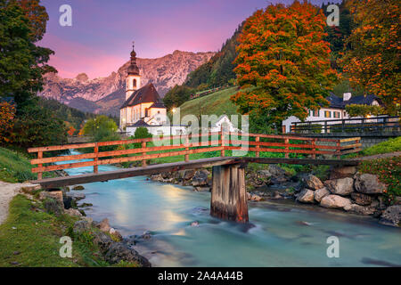 Autumn in Alps. Image of the Bavarian Alps with Parish Church of St. Sebastian located in Ramsau bei Berchestgaden, Germany during beautiful autumn su Stock Photo