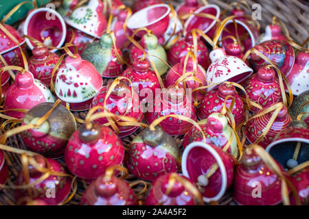 Bright red white green ceramic Christmas bells as Christmas background. Selective focus Stock Photo