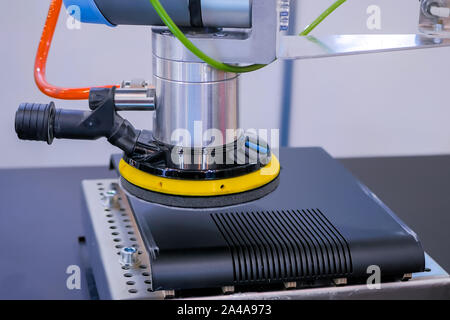 Automated robotic arm moves and places objects at trade show, exhibition Stock Photo