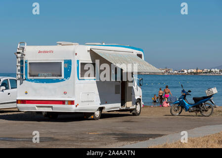 Gouves, Crete, Greece. October 2019. An old motorhome on the beach at Kato Gouves on an area which had been a US military base near Heraklion, Crete.