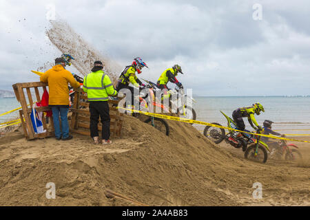 Weymouth, Dorset, UK. 13th October 2019. Motocross racing on Weymouth Beach. Practicing just before a marshal suffered a serious injury from a bike at this spot - it is not known the extent of his injuries, but an air ambulance landed on the beach. Credit: Carolyn Jenkins/Alamy Live News Stock Photo
