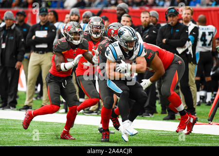 London, UK.  13 October 2019. Panthers Running Back, Christian McCaffrey (22) is tackled during the NFL match Tampa Bay Buccaneers v Carolina Panthers at Tottenham Hotspur Stadium.  Credit: Stephen Chung / Alamy Live News Stock Photo