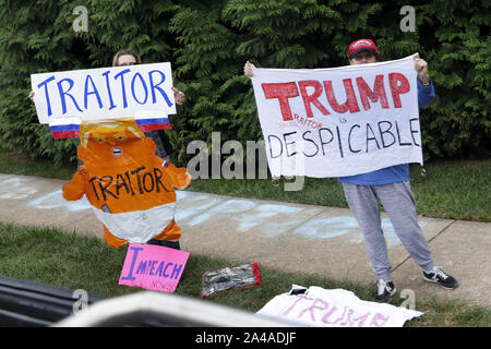 Sterling, USA. 13th Oct, 2019. Protesters gather outside as U.S. President Donald Trump's motorcade arrives at Trump National Golf Club in Sterling, Virginia on October 13, 2019. Photo by Yuri Gripas/UPI Credit: UPI/Alamy Live News