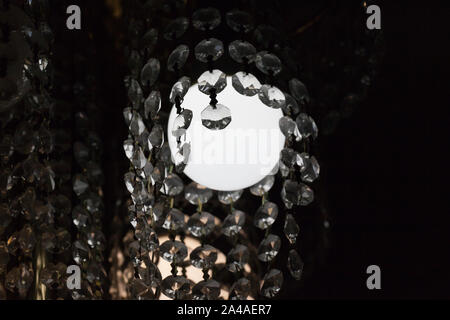 The led lamp shines brightly in the chandelier with decorations Stock Photo