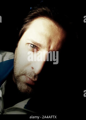 Portrait of a man in the darkenss - Photography Stock Photo