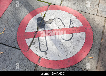 A no smoking sign painted on to the pavement of a private area on a city street Stock Photo