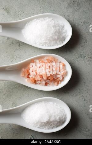 Different types of salt on a spoons. Stock Photo