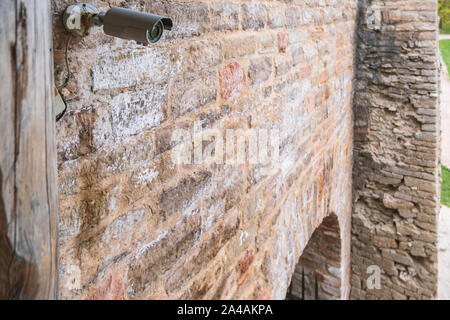 Modern video surveillance system on the wall of an old fortress. Close-up. Stock Photo