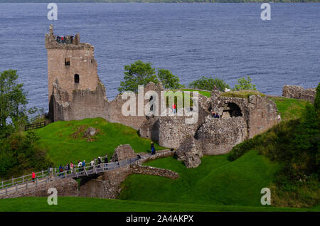 Tourists visit the ruins of Urquhart Castle near Drumnadrochit on the banks of Loch Ness Inverness-shire Scotland UK Stock Photo