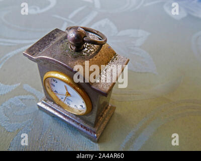 Old weathered miniature clock, close up. Stock Photo