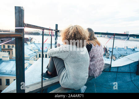 two teenagers girl friends having fun on roof top, liestyle people traveling europe concept