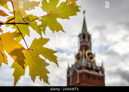 Autumn leaves on the background of the Spasskaya tower of the Moscow Kremlin, Russia Stock Photo