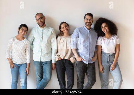 Portrait of smiling young diverse people standing in row Stock Photo