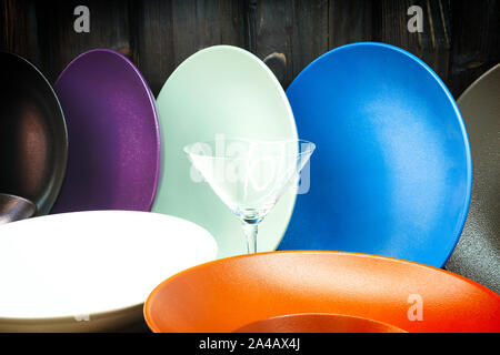 multi-colored dishes utensils on a wooden background Stock Photo