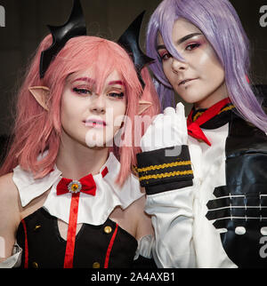 NEC, BIRMINGHAM, UK - JUNE 1, 2019. Two confident, female cosplayers dressed as Japanese Anime characters with colourful wigs and make up at a comic c Stock Photo