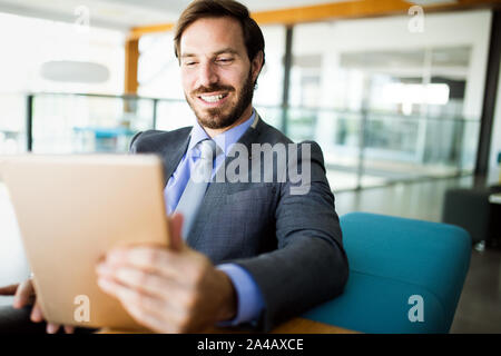 Elegant business multitasking multimedia man using devices Stock Photo