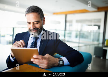 Elegant business multitasking multimedia man using devices Stock Photo